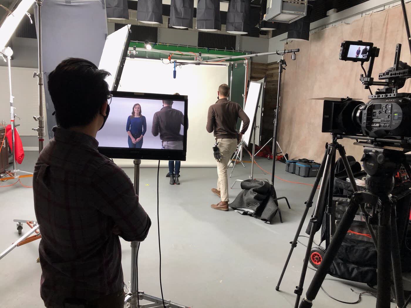 Crew filming an interview setup in studio