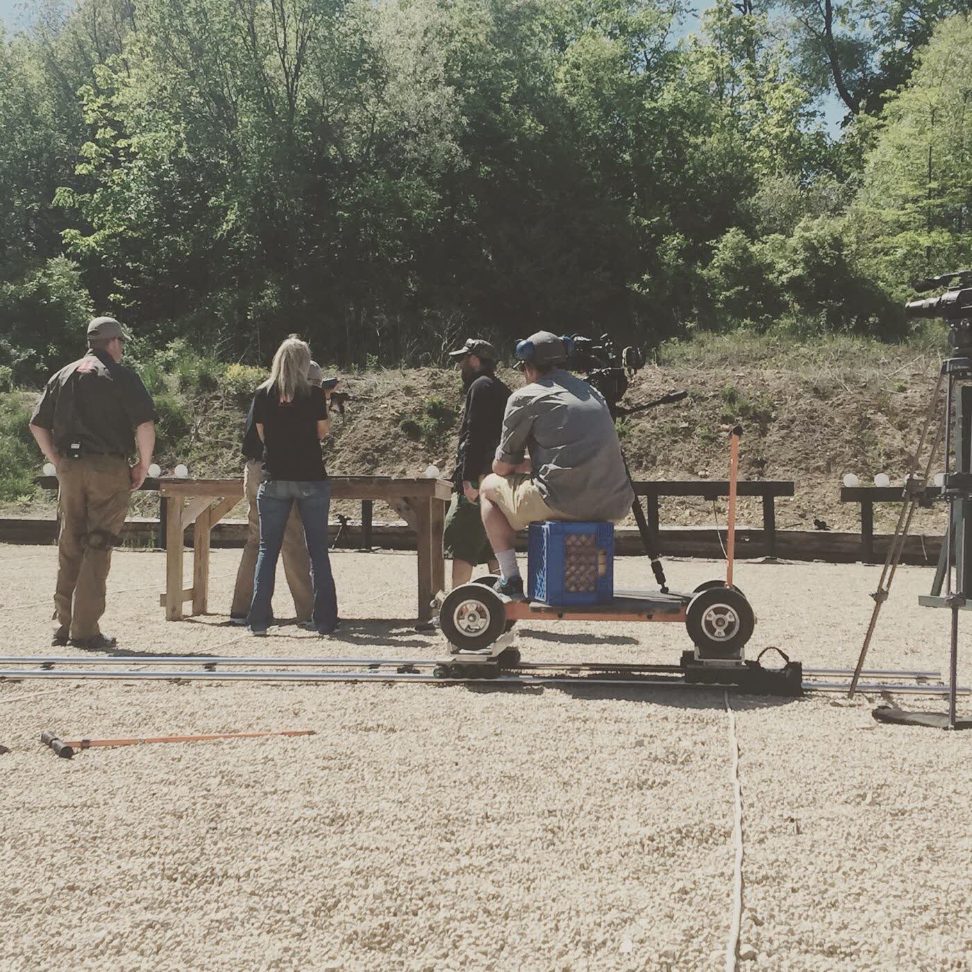 Camera operator on a dolly at a gravel range