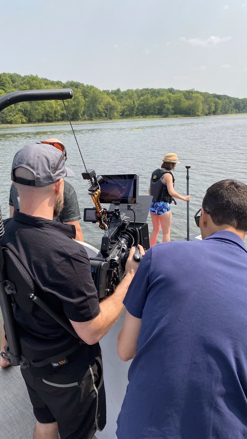 Crew filming from a boat on the water