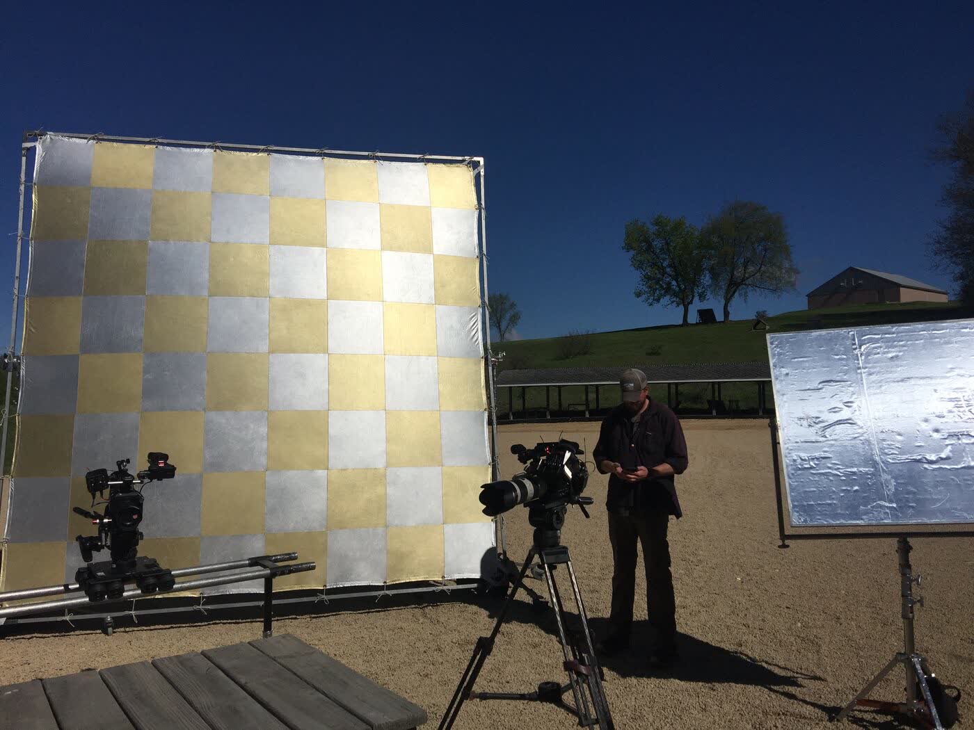 Camera operator on a slider in a rural field